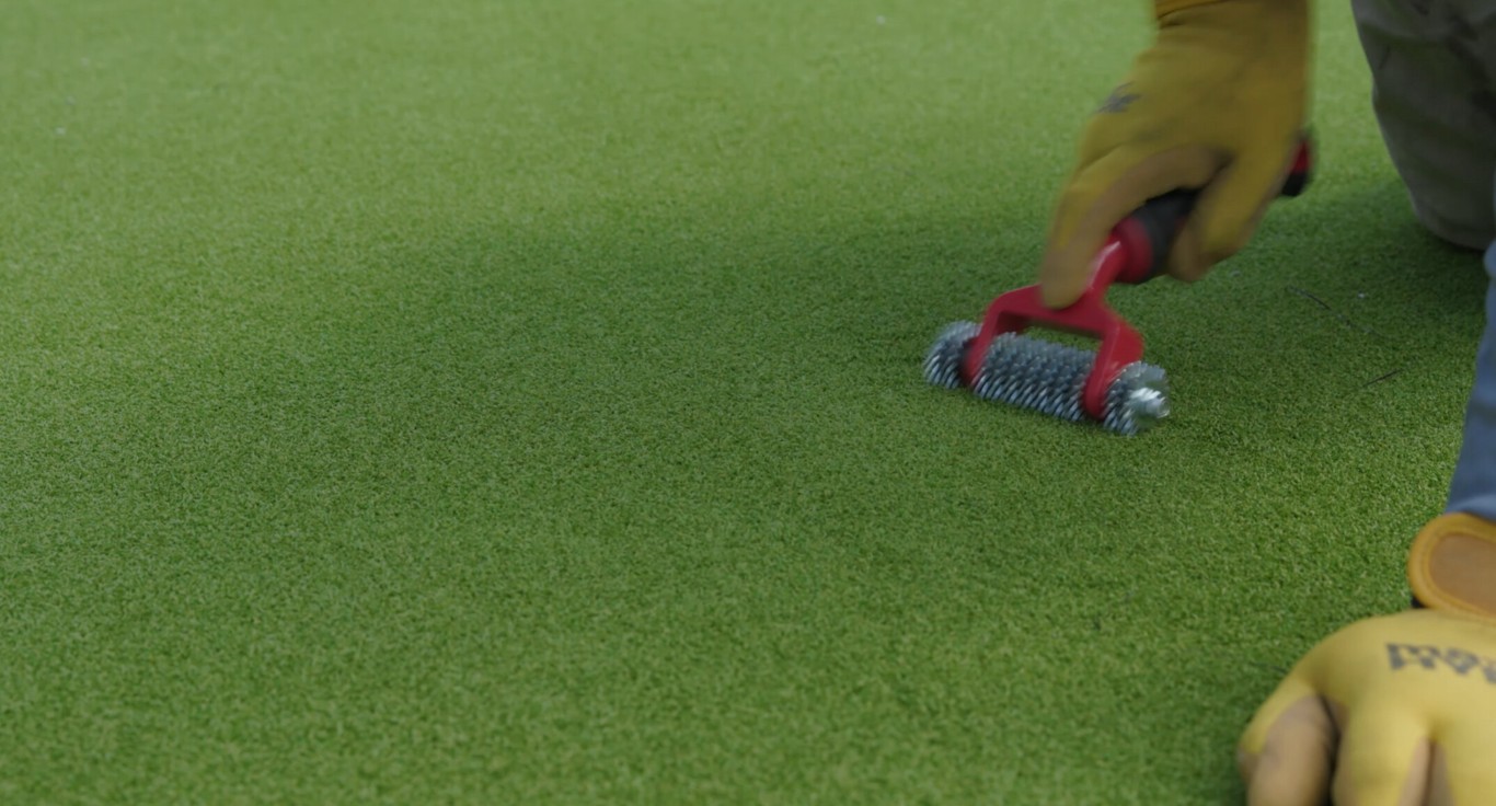 Ultra-durable playground safety turf being maintained